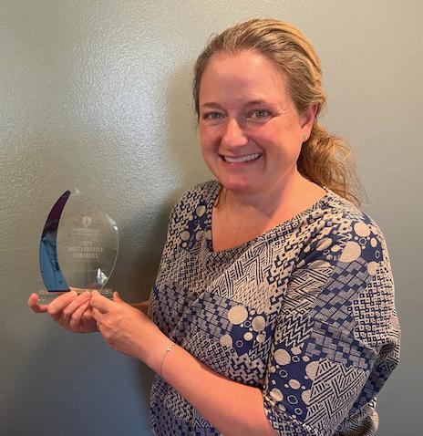 Cindy McReynolds, CEO of EicOsis, with the award.