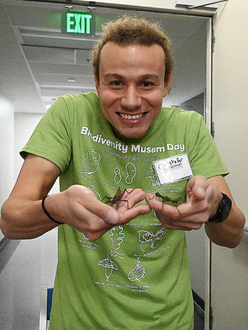 UC Davis doctoral student Christofer Brothers shows tenants of the Bohart Museum's petting zoo.