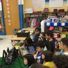 Nicole Korzeniecki, now Nicole Keough, leading an outreach event. As an undergraduate student, she was volunteering at a public ESL (English-as-second language) elementary school, teaching first-grade students about ant physiology and anatomy.